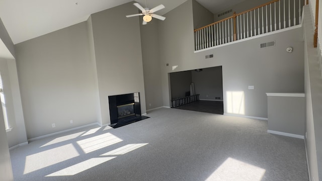 41664 Tera Ln, Novi, MI 48375 - unfurnished living room with high vaulted ceiling, carpet flooring, a ceiling fan, and a fireplace with flush hearth