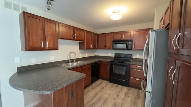 41664 Tera Ln, Novi, MI 48375 - kitchen with black appliances, dark countertops, a peninsula, light wood-type flooring, and brown cabinets