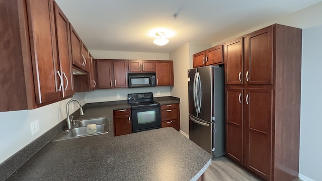 41664 Tera Ln, Novi, MI 48375 - kitchen with black appliances, dark countertops, a peninsula, and light wood finished floors