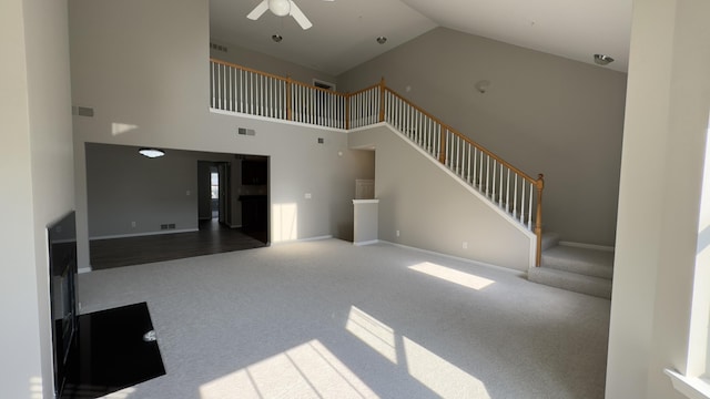 41664 Tera Ln, Novi, MI 48375 - unfurnished living room with high vaulted ceiling, carpet, ceiling fan, and stairway