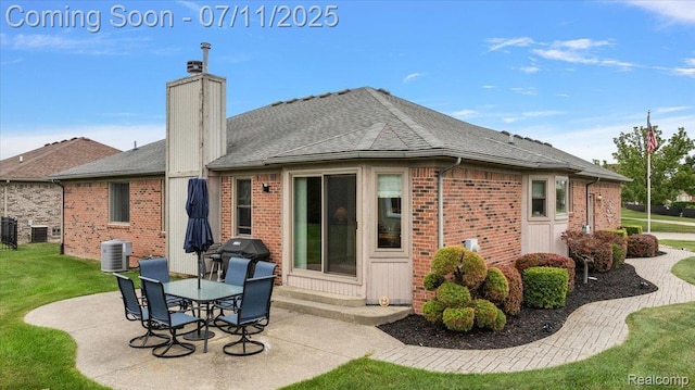 54561 Laurel Dr, Macomb, MI 48042 - back of house featuring brick siding, a patio area, a lawn, and roof with shingles