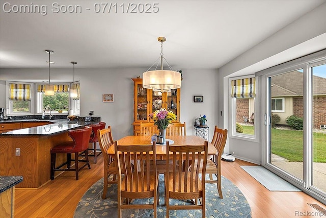 54561 Laurel Dr, Macomb, MI 48042 - dining area featuring light wood-style flooring and a chandelier