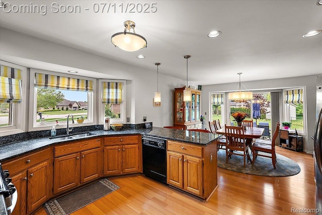 54561 Laurel Dr, Macomb, MI 48042 - kitchen featuring black dishwasher, brown cabinetry, light wood-style flooring, a peninsula, and hanging light fixtures