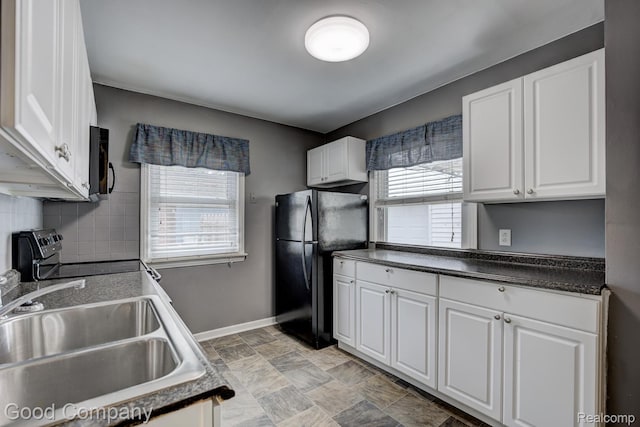 1977 Princeton Rd, Troy, MI 48072 - kitchen featuring freestanding refrigerator, electric stove, white cabinets, dark countertops, and decorative backsplash