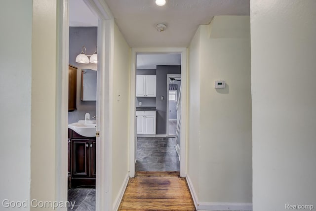 1977 Princeton Rd, Troy, MI 48072 - hall with baseboards and wood finished floors