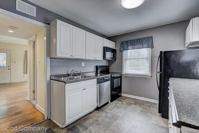 1977 Princeton Rd, Troy, MI 48072 - kitchen featuring black appliances, white cabinets, backsplash, and dark countertops
