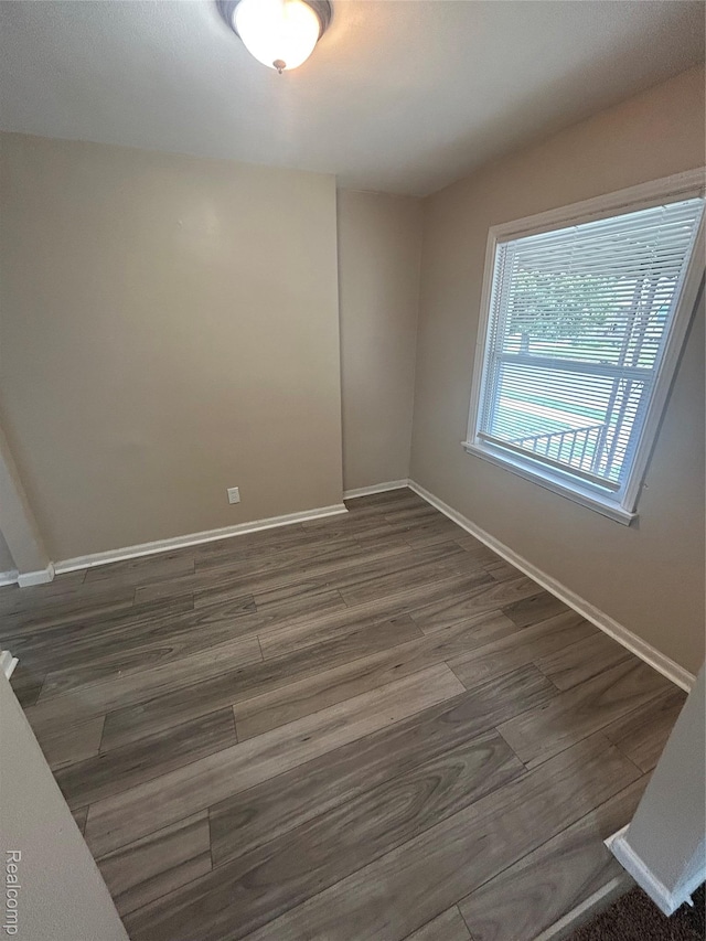 3381 S Ethel St, Detroit, MI 48217 - empty room featuring dark wood-type flooring and baseboards