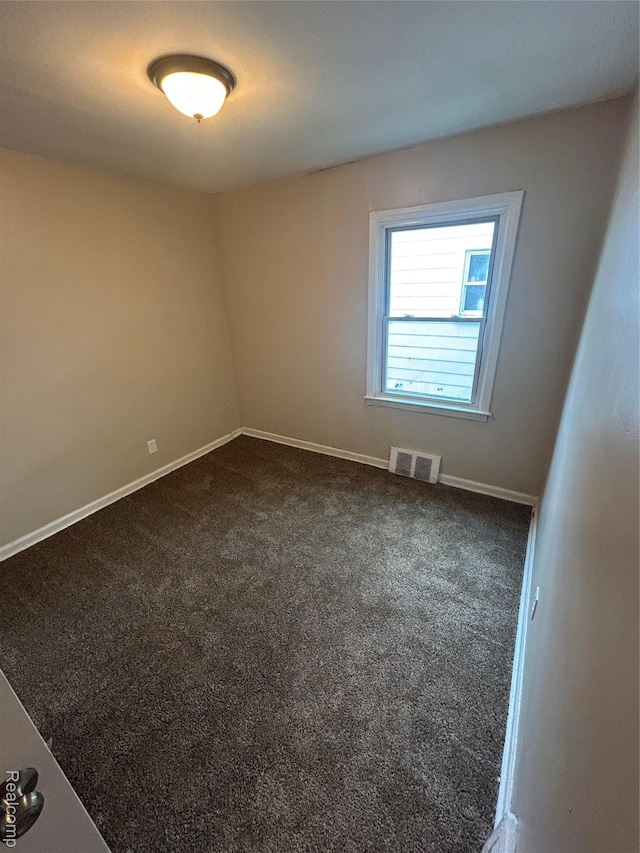 3381 S Ethel St, Detroit, MI 48217 - spare room featuring dark colored carpet and baseboards