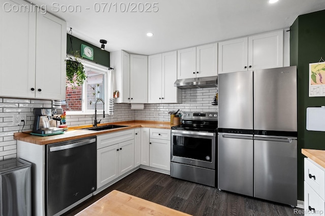 23316 Brookdale Blvd, Saint Clair Shores, MI 48082 - kitchen with stainless steel appliances, butcher block counters, under cabinet range hood, dark wood-style flooring, and decorative backsplash