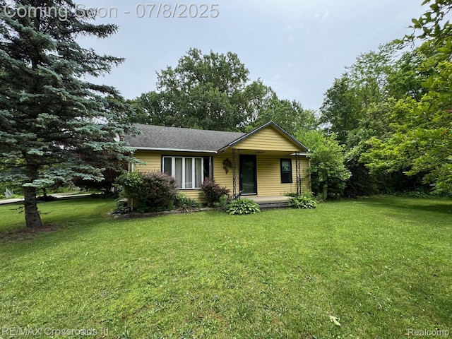 6785 Belleville Rd, Van Buren, MI 48111 - view of front of house featuring a front yard, covered porch, and a shingled roof