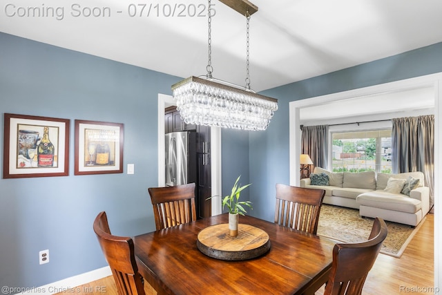 4247 Morningview Dr, Shelby Twp, MI 48316 - dining area with a chandelier and light wood finished floors