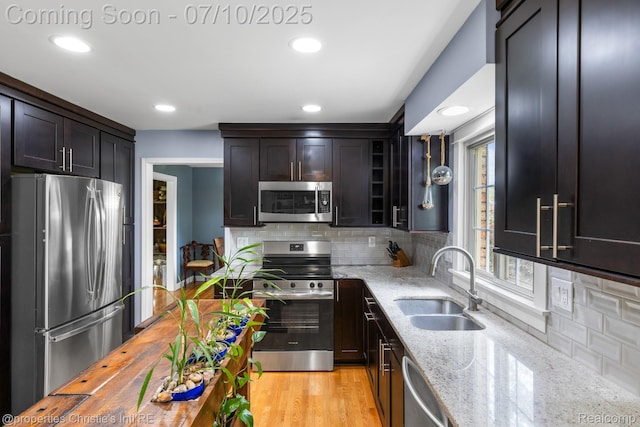 4247 Morningview Dr, Shelby Twp, MI 48316 - kitchen with appliances with stainless steel finishes, light stone counters, backsplash, recessed lighting, and glass insert cabinets