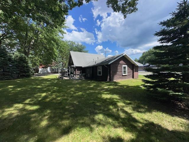 3786 W Houghton Lake Dr, Houghton Lake, MI 48629 - view of side of property featuring a lawn