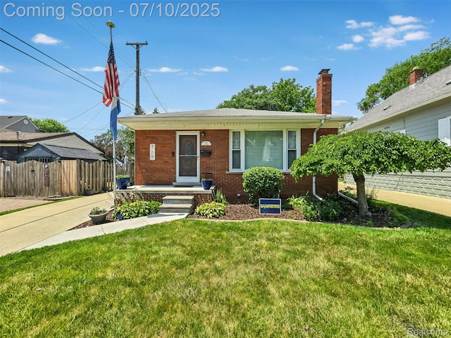 144 1st St, Wyandotte, MI 48192 - view of front of home with brick siding and a chimney