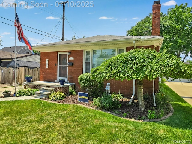 144 1st St, Wyandotte, MI 48192 - view of front of house featuring a chimney and brick siding