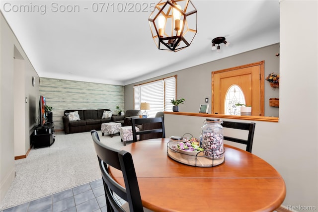 144 1st St, Wyandotte, MI 48192 - carpeted dining room featuring an accent wall, wallpapered walls, tile patterned floors, and a chandelier