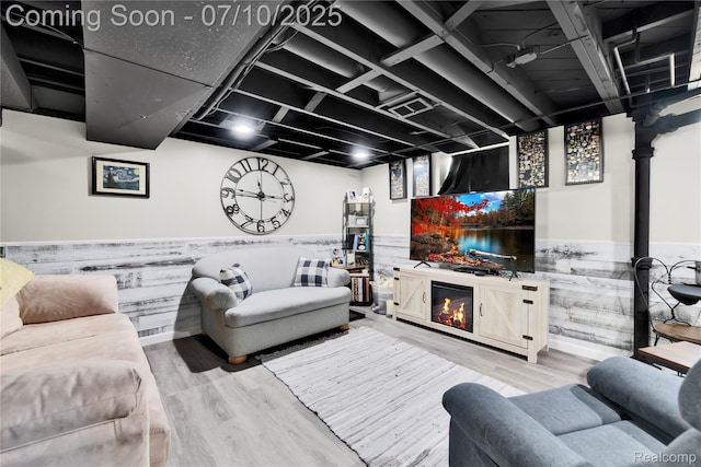 144 1st St, Wyandotte, MI 48192 - living room with a wainscoted wall, wood finished floors, and a warm lit fireplace