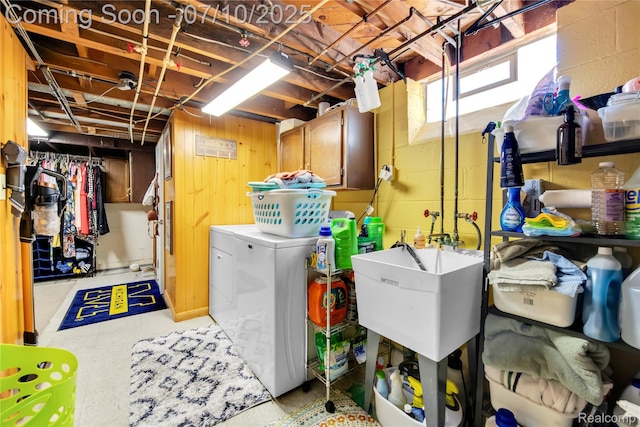 144 1st St, Wyandotte, MI 48192 - laundry room with cabinet space, separate washer and dryer, and concrete block wall