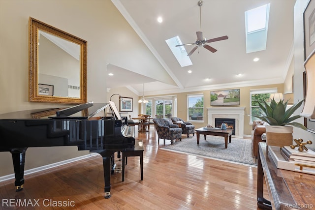 30166 Brightwood Dr Unit 40, Novi, MI 48377 - living area featuring a skylight, high vaulted ceiling, a glass covered fireplace, light wood finished floors, and ceiling fan