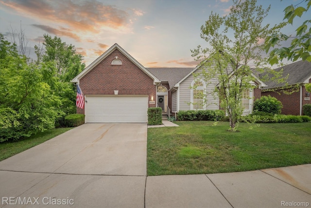30166 Brightwood Dr Unit 40, Novi, MI 48377 - view of front facade with brick siding, concrete driveway, a garage, and a lawn
