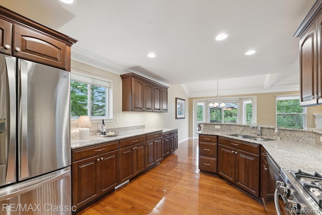 30166 Brightwood Dr Unit 40, Novi, MI 48377 - kitchen with stainless steel appliances, crown molding, a chandelier, light wood-style flooring, and healthy amount of natural light