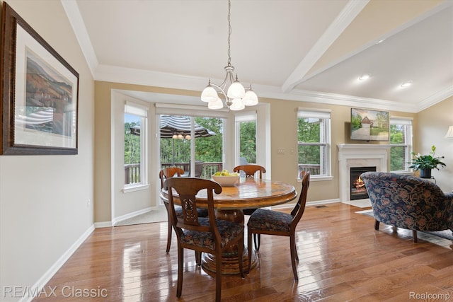 30166 Brightwood Dr Unit 40, Novi, MI 48377 - dining room featuring healthy amount of natural light, a chandelier, crown molding, light wood finished floors, and vaulted ceiling