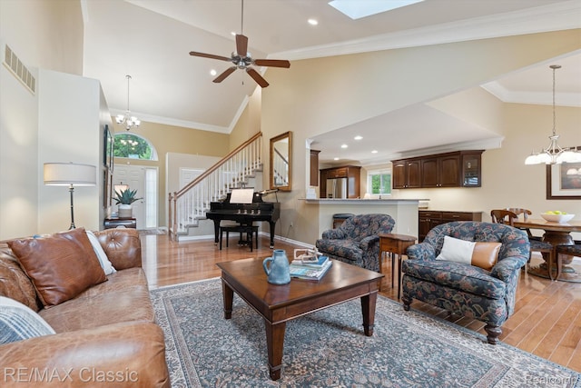 30166 Brightwood Dr Unit 40, Novi, MI 48377 - living area with a chandelier, light wood-style floors, stairway, high vaulted ceiling, and a ceiling fan