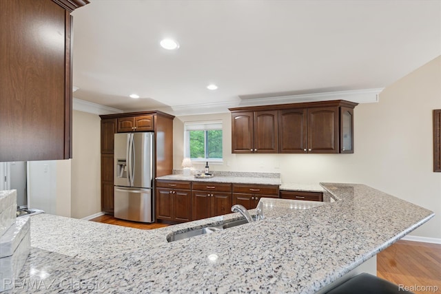 30166 Brightwood Dr Unit 40, Novi, MI 48377 - kitchen with stainless steel fridge, light wood-style flooring, crown molding, light stone countertops, and a peninsula