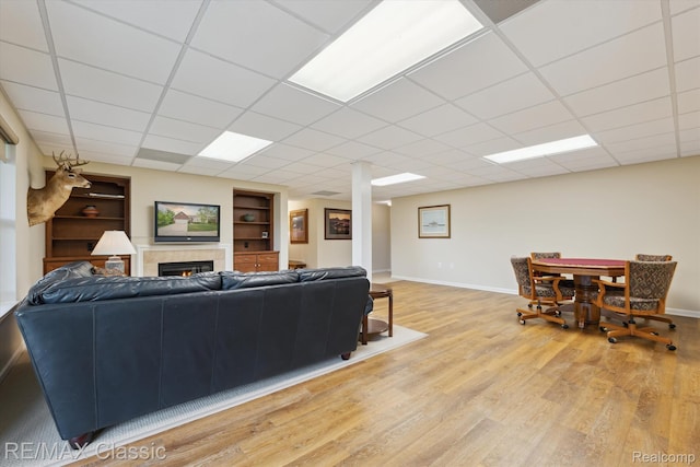 30166 Brightwood Dr Unit 40, Novi, MI 48377 - living area with light wood-style floors, built in features, a fireplace, and a paneled ceiling