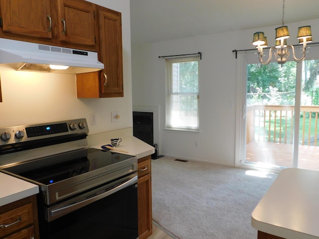 36561 S Deerhurst S, Westland, MI 48185 - kitchen with stainless steel electric range oven, under cabinet range hood, light carpet, brown cabinets, and light countertops