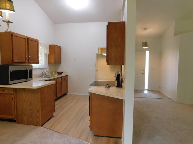 36561 S Deerhurst S, Westland, MI 48185 - kitchen featuring stainless steel microwave, brown cabinets, light countertops, and vaulted ceiling