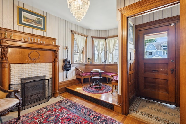 501 E Michigan Ave, Marshall, MI 49068 - foyer entrance featuring wood finished floors, a chandelier, and a fireplace with flush hearth