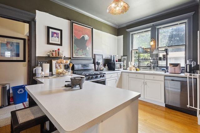 501 E Michigan Ave, Marshall, MI 49068 - kitchen with appliances with stainless steel finishes, light countertops, white cabinetry, crown molding, and a peninsula