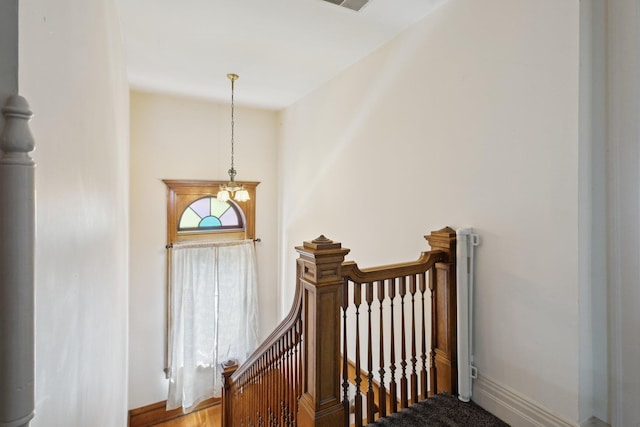 501 E Michigan Ave, Marshall, MI 49068 - stairway featuring a chandelier and baseboards