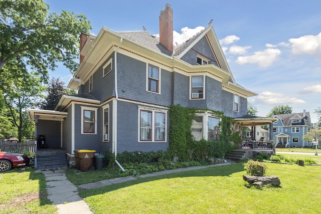 501 E Michigan Ave, Marshall, MI 49068 - view of side of property featuring a chimney, a lawn, and covered porch