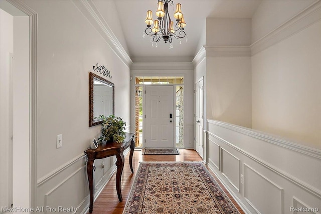 838 Knolls Landing Dr Unit 6, Milford, MI 48381 - entryway featuring a chandelier, a decorative wall, a wainscoted wall, and light wood-type flooring