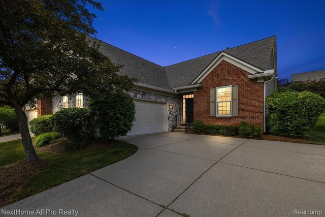 838 Knolls Landing Dr Unit 6, Milford, MI 48381 - view of front of home with driveway, a garage, a shingled roof, brick siding, and stone siding