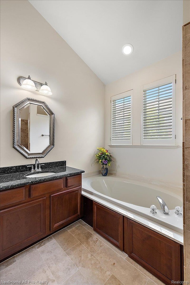 838 Knolls Landing Dr Unit 6, Milford, MI 48381 - bathroom featuring a garden tub and vanity