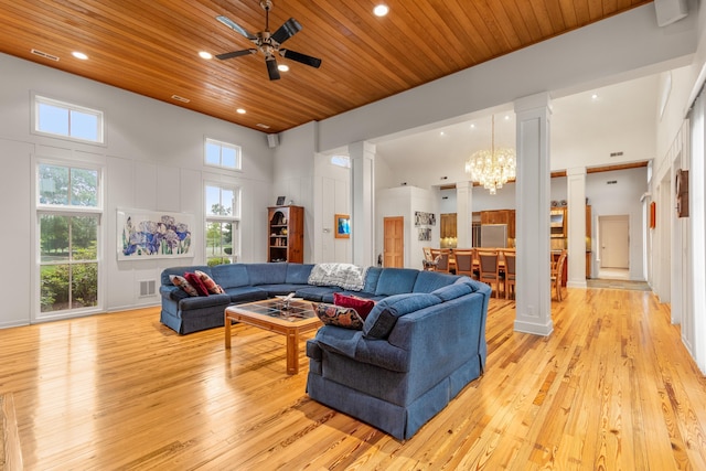 14091 Scio Church Rd, Chelsea, MI 48118 - living area featuring decorative columns, light wood-style flooring, wood ceiling, a towering ceiling, and a chandelier