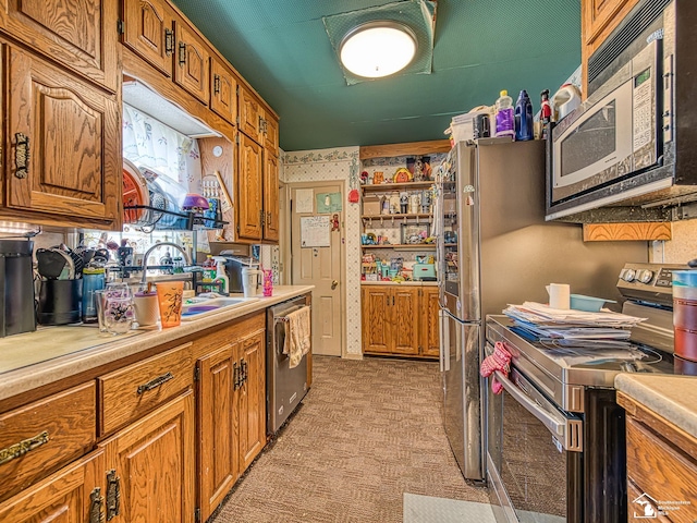 476 Borgess Ave, Monroe, MI 48162 - kitchen featuring stainless steel appliances, light countertops, and brown cabinetry