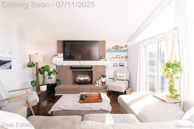 8856 Charbane Ave, White Lake, MI 48386 - living room featuring wood finished floors, a fireplace, and vaulted ceiling