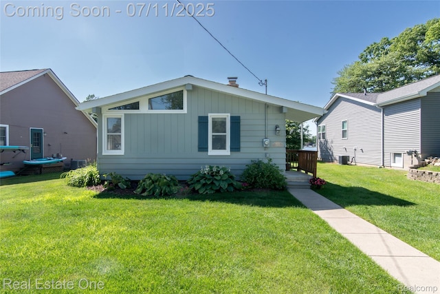 8856 Charbane Ave, White Lake, MI 48386 - bungalow with a front lawn and board and batten siding