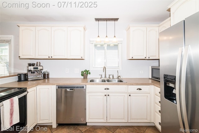 8856 Charbane Ave, White Lake, MI 48386 - kitchen with appliances with stainless steel finishes, decorative light fixtures, light countertops, and tile patterned floors