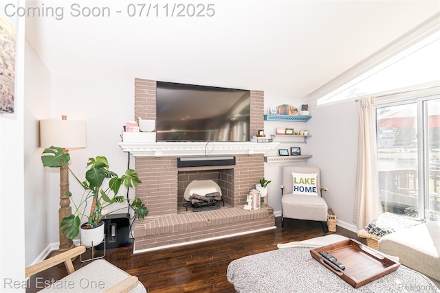8856 Charbane Ave, White Lake, MI 48386 - living room with wood finished floors, lofted ceiling, and a fireplace