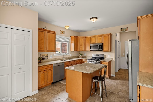5142 Trailwood Ln, Warren, MI 48092 - kitchen with stainless steel appliances, a breakfast bar area, a kitchen island, light stone counters, and brown cabinetry