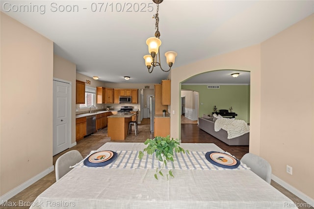 5142 Trailwood Ln, Warren, MI 48092 - dining area with a chandelier and arched walkways