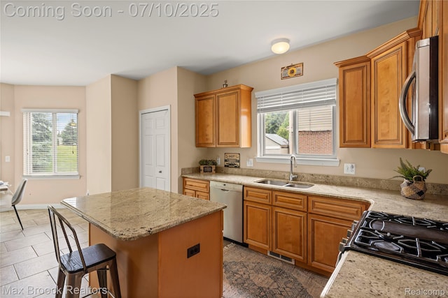 5142 Trailwood Ln, Warren, MI 48092 - kitchen with appliances with stainless steel finishes, healthy amount of natural light, a kitchen breakfast bar, and brown cabinetry