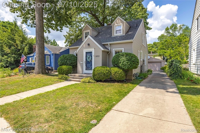 903 Oakridge Ave, Royal Oak, MI 48067 - new england style home featuring a front yard, roof with shingles, a detached garage, and an outdoor structure