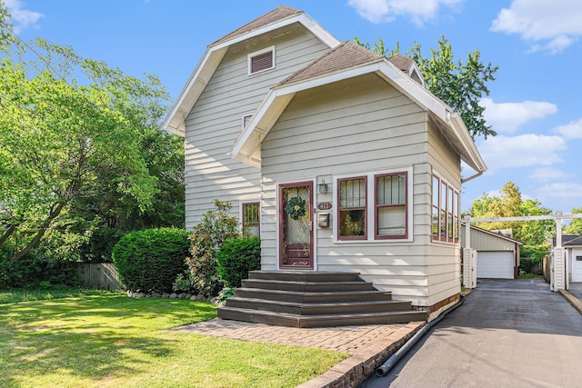 411 Edgemoor Ave, Kalamazoo, MI 49001 - view of front of property featuring a garage, a front yard, entry steps, and an outbuilding