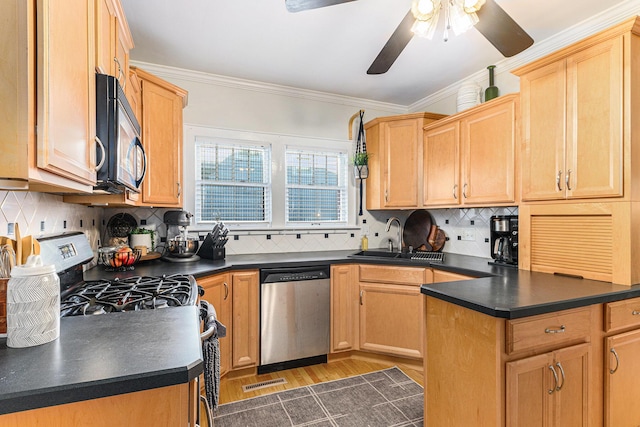 411 Edgemoor Ave, Kalamazoo, MI 49001 - kitchen with appliances with stainless steel finishes, dark countertops, ceiling fan, light wood-style flooring, and ornamental molding